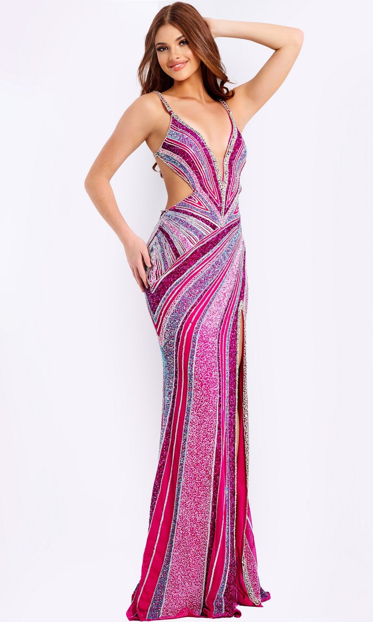Woman in the Jovani 46206, a pink sleeveless floor-length sequin sheath prom dress with stripes, deep V-neckline, side cutouts, and thigh-high slit, poses against a white background. Perfect choice for prom night.